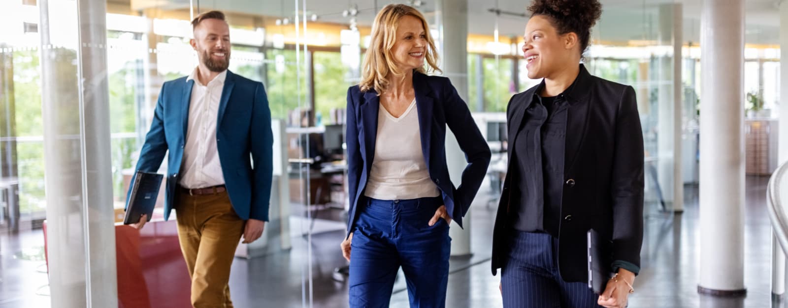 3 people walking through bank